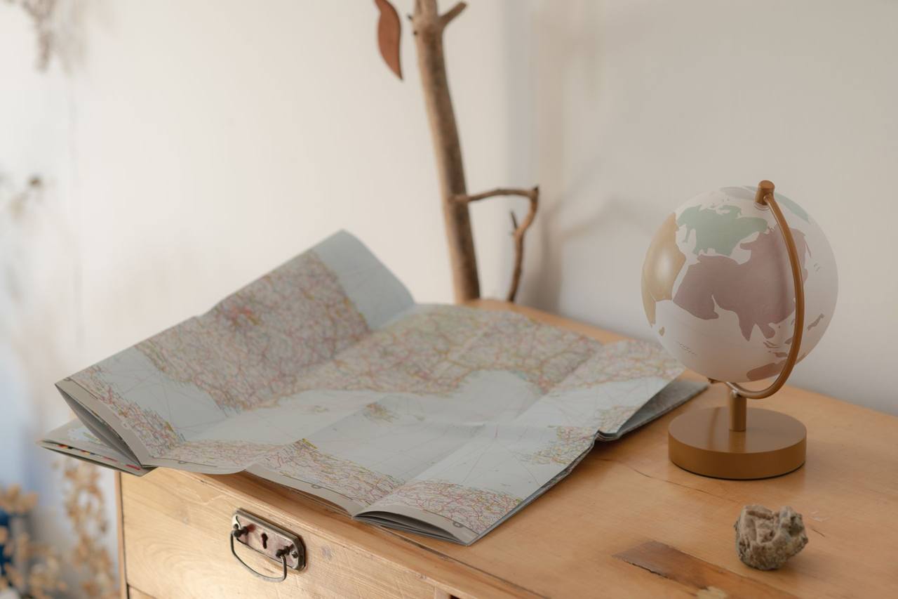 Vintage globe and map on a wooden table