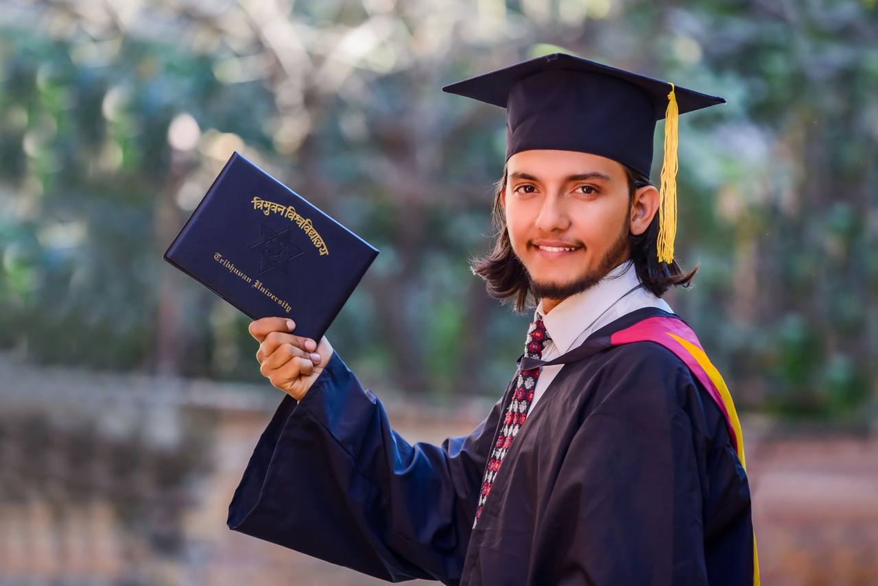 Graduate in cap and gown holding a diploma