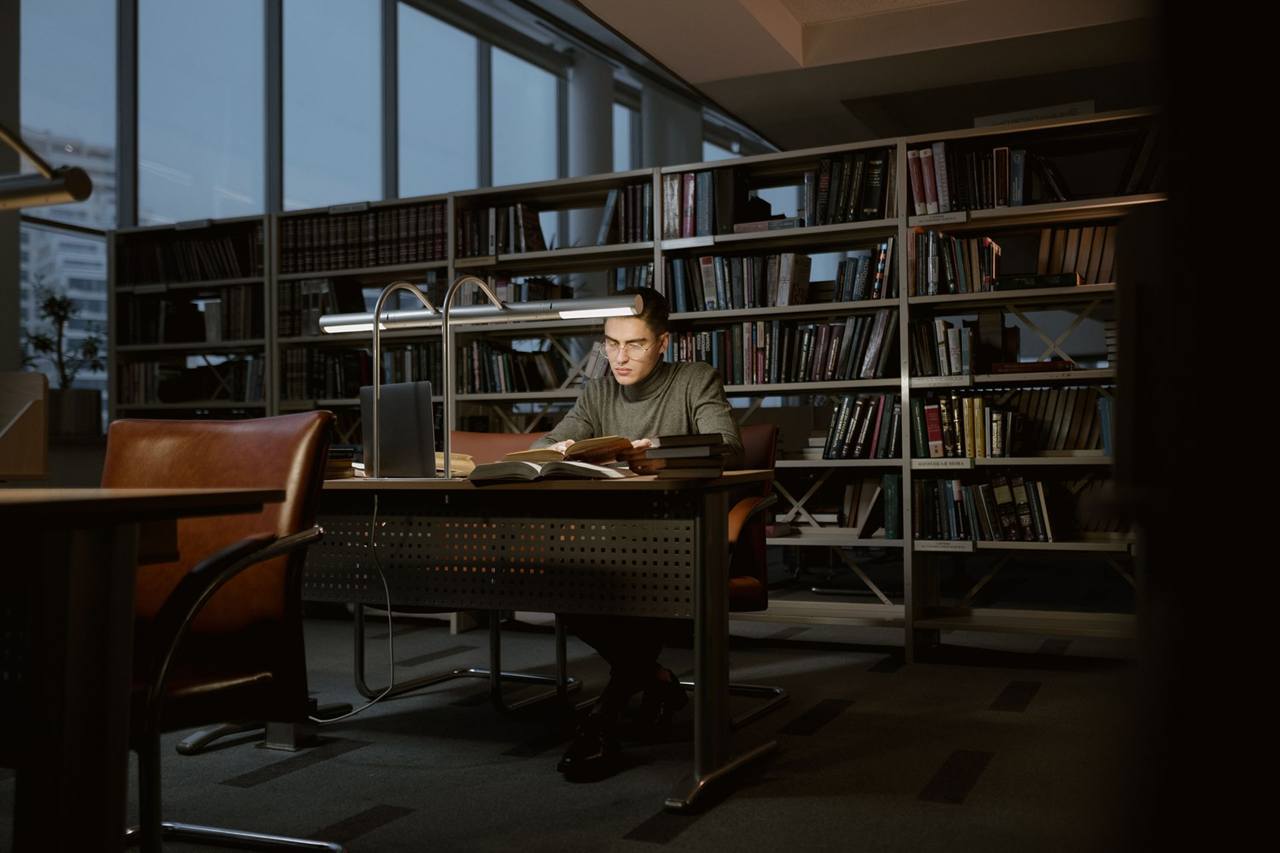 Student reading in a quiet library